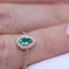 A chain ring with an emerald drop and diamonds around it - Image 2