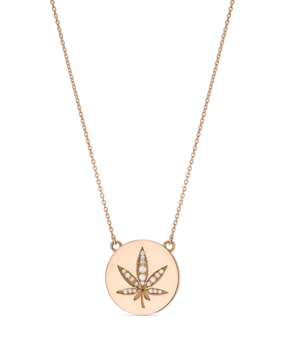 A round pendant with a leaf of grass studded with diamonds