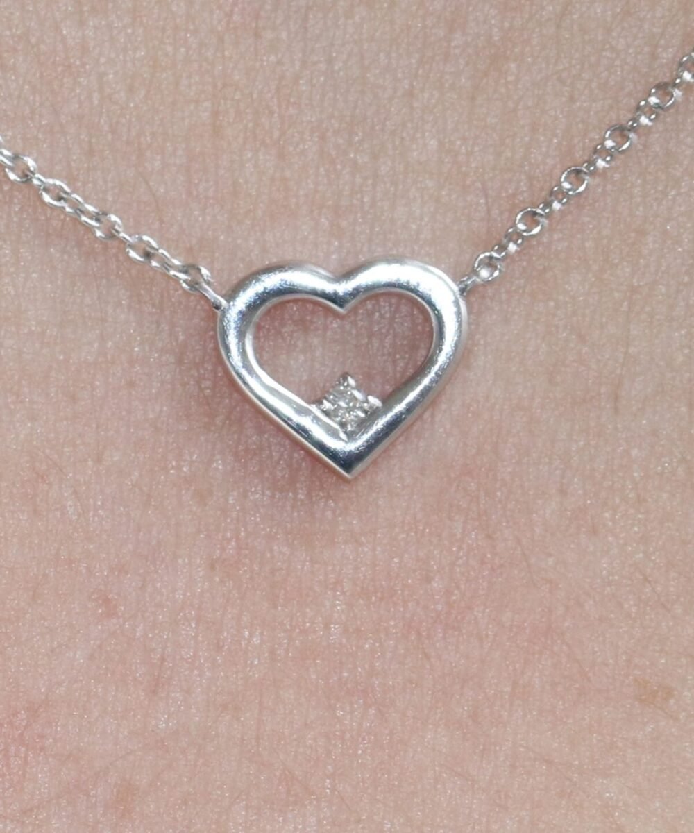 A heart-shaped pendant with a diamond